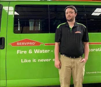 Employee in front of SERVPRO truck 