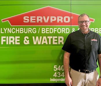 Employee in front of SERVPRO truck 